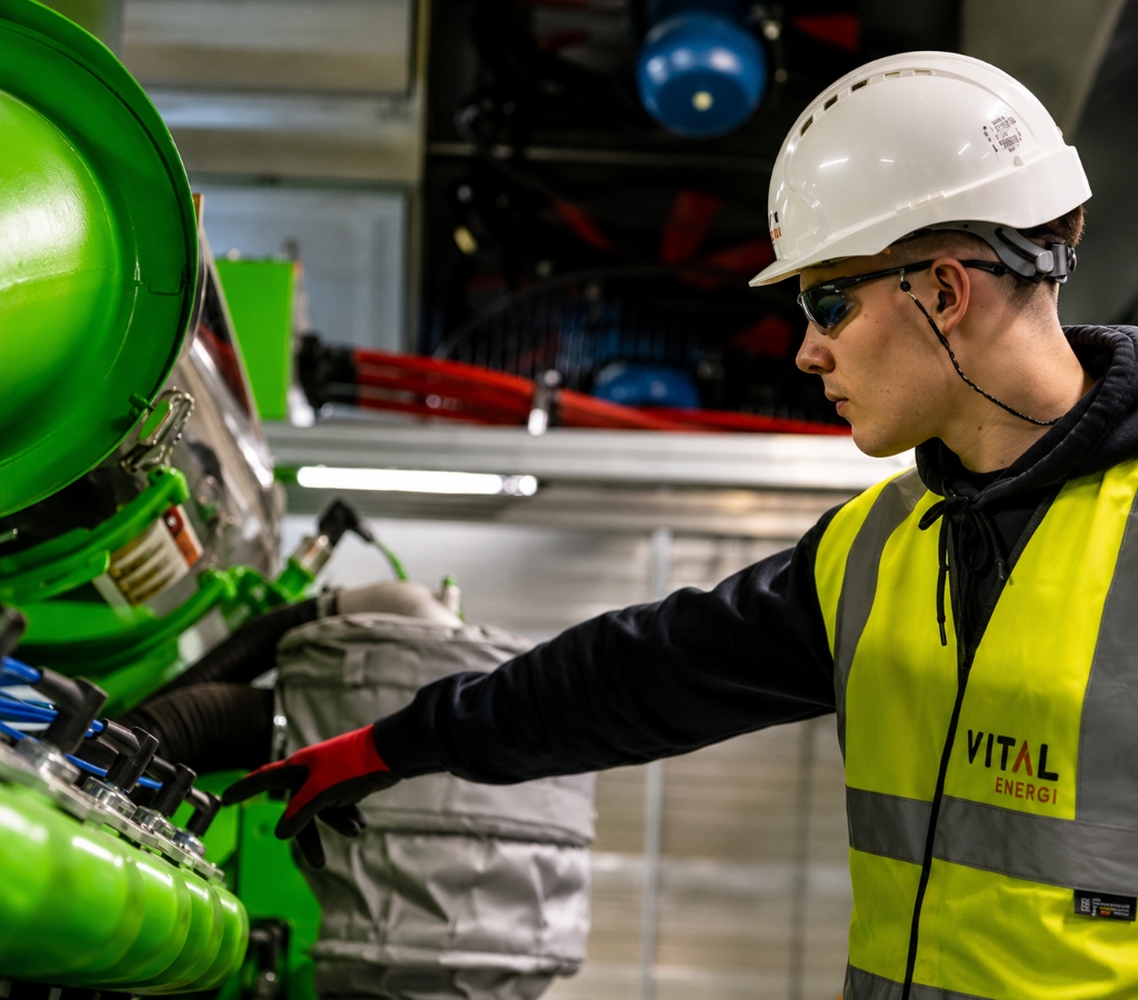 Technician inspecting industrial equipment for maintenance planning