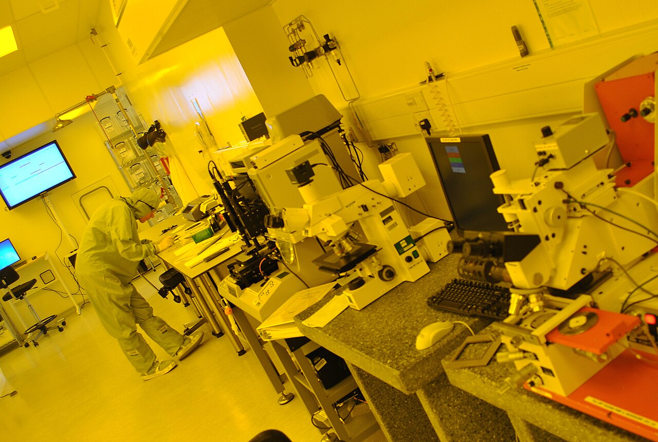 Technician working inside a semiconductor clean room
