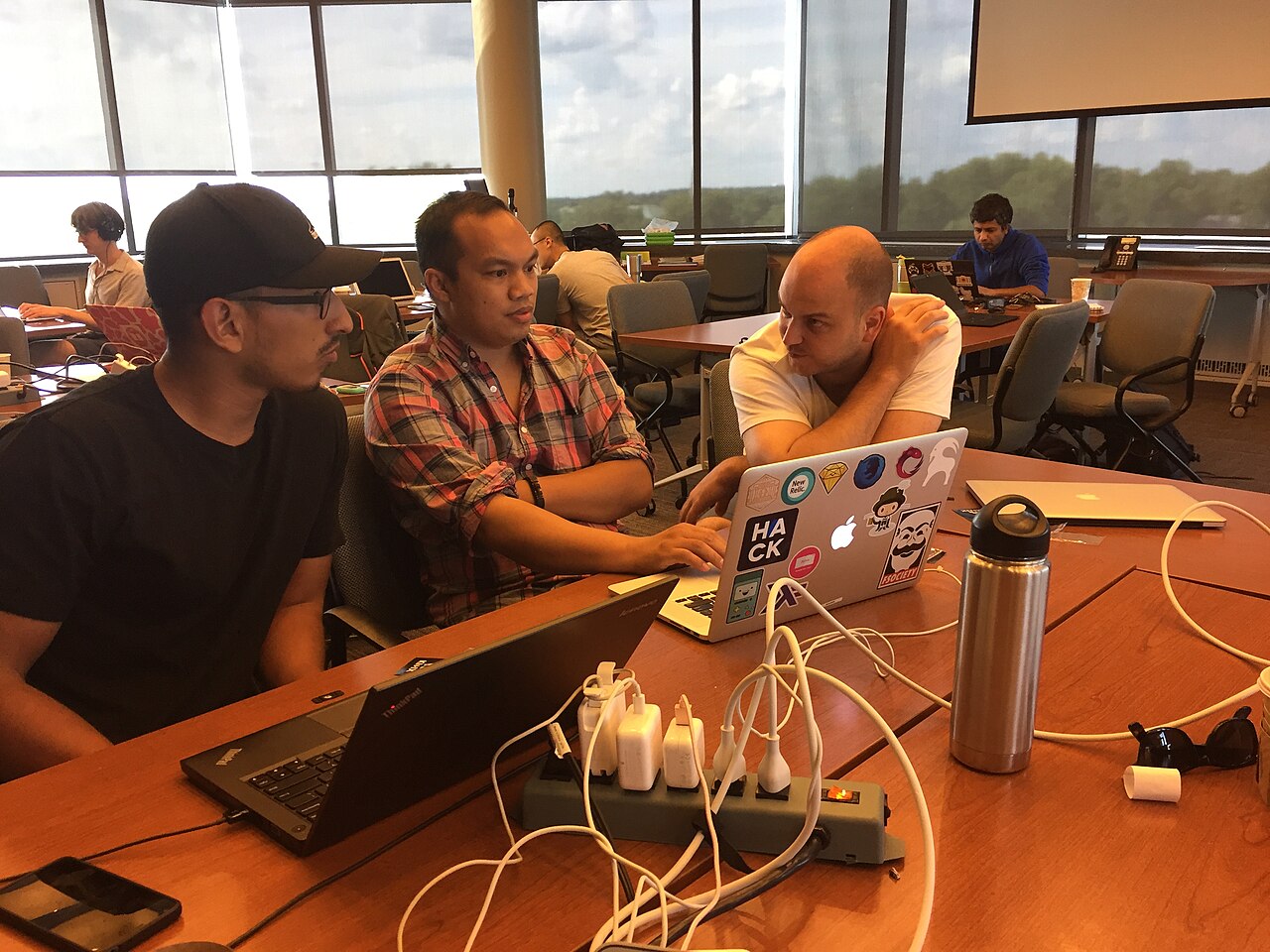 Software engineers working together at laptops